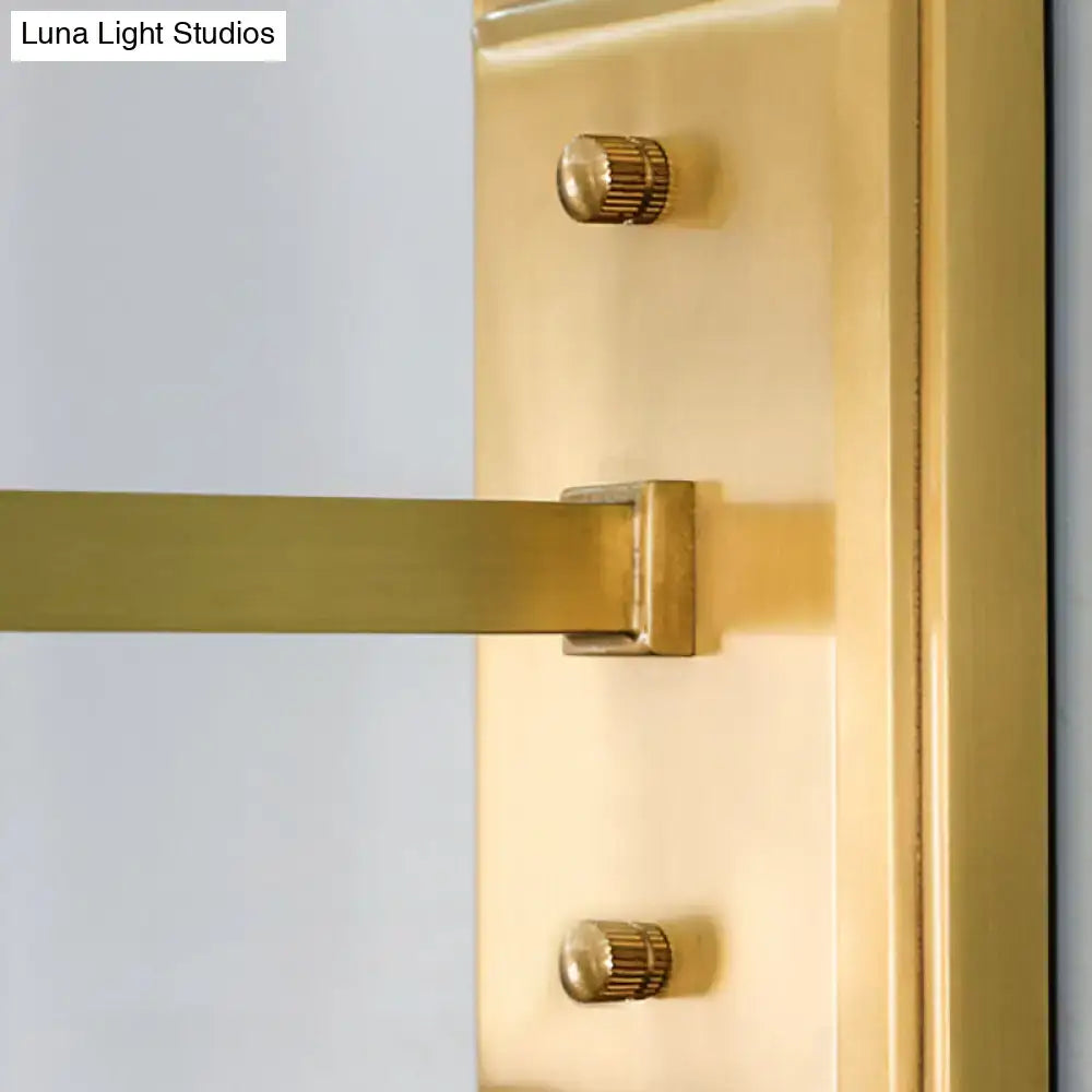Gold-finished brass door handle with sleek modern design and two matching knurled knobs for contemporary wall sconce