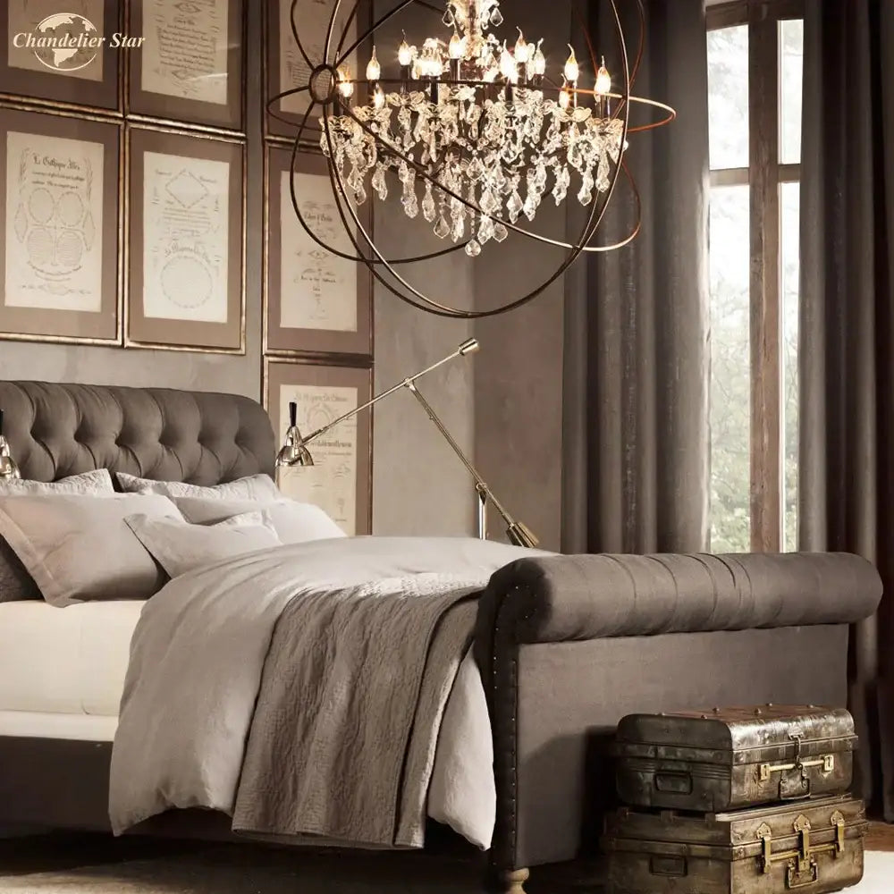 A sophisticated dark gray tufted velvet sleigh bed with nailhead trim paired with a contemporary decorbites crystal led chandelier