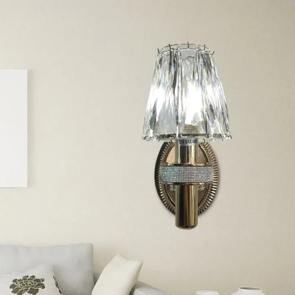Contemporary bronze wall sconce light with crystal-encrusted brass and tiered faceted glass shade for bedroom use