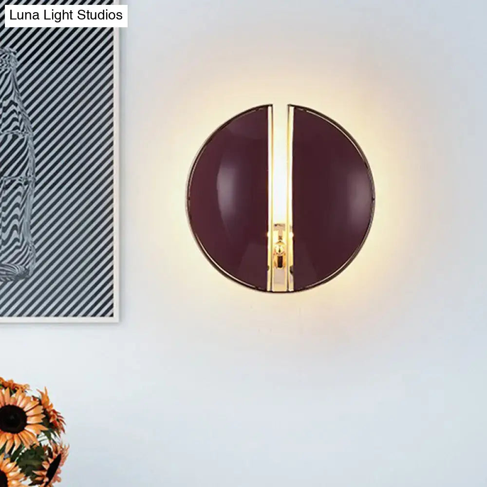Contemporary wall lamp with a modern circular design, glossy dark purple finish, and central gold-toned accent strip