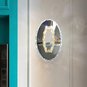 Contemporary chrome crystal oval light fixture mirror with beveled frame and warm white illuminated gold-toned element