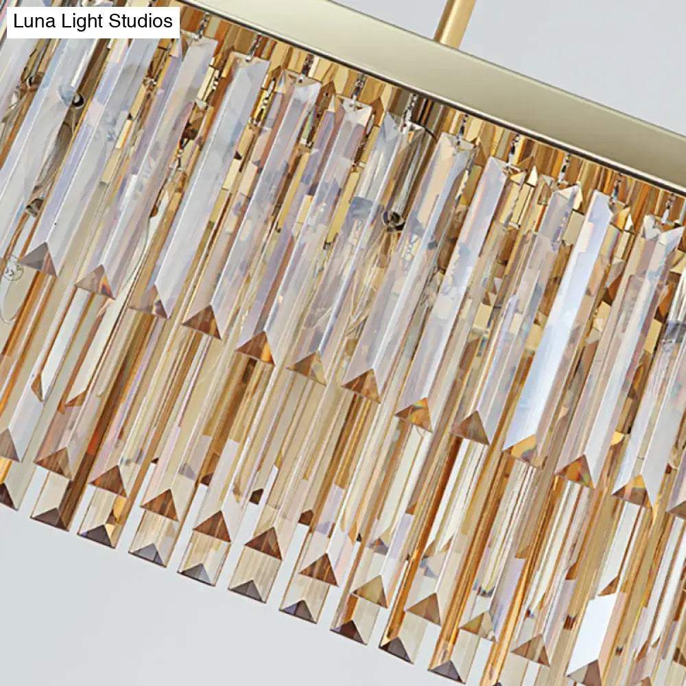 Gold-toned contemporary dining room chandelier light fixture with cascading clear amber crystal prisms
