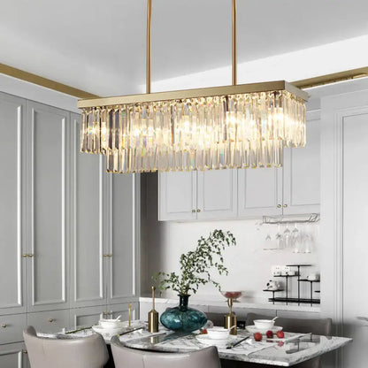 Gold-toned rectangular contemporary light fixture with cascading clear amber crystal prisms for dining room chandelier