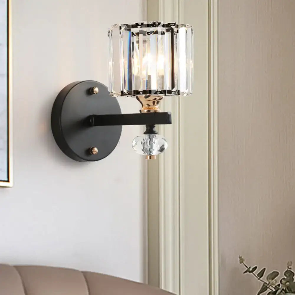 Contemporary clear ribbed glass drum sconce light with black metal frame and crystal cylinder shade for bedroom use
