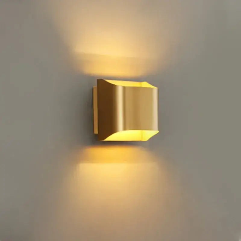Contemporary copper brass wall sconce with gold color and sleek metallic finish by decorbites for living room decor