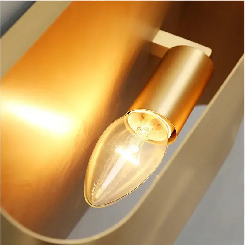 A warm-toned contemporary copper brass wall sconce with clear glass candle bulb for living room decorbites contemporary copper