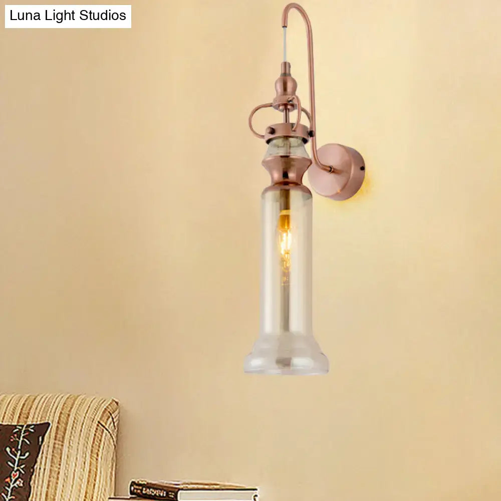 Contemporary copper wall sconce with a smoke gray amber glass shade and rose gold metal frame featuring exposed bulb