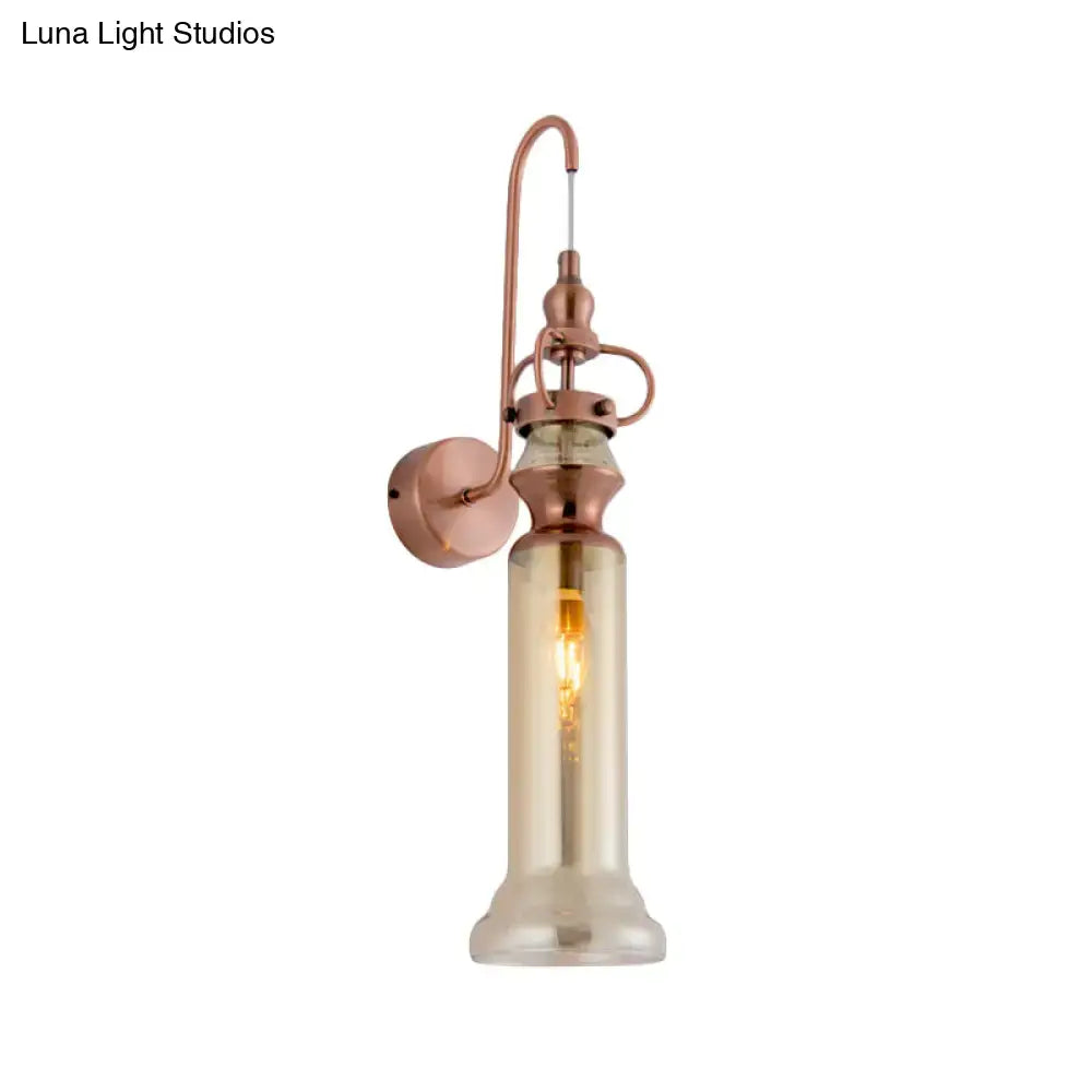 Contemporary copper wall sconce with tall amber-tinted glass cylinder and smoke gray amber glass shade for bedroom lighting