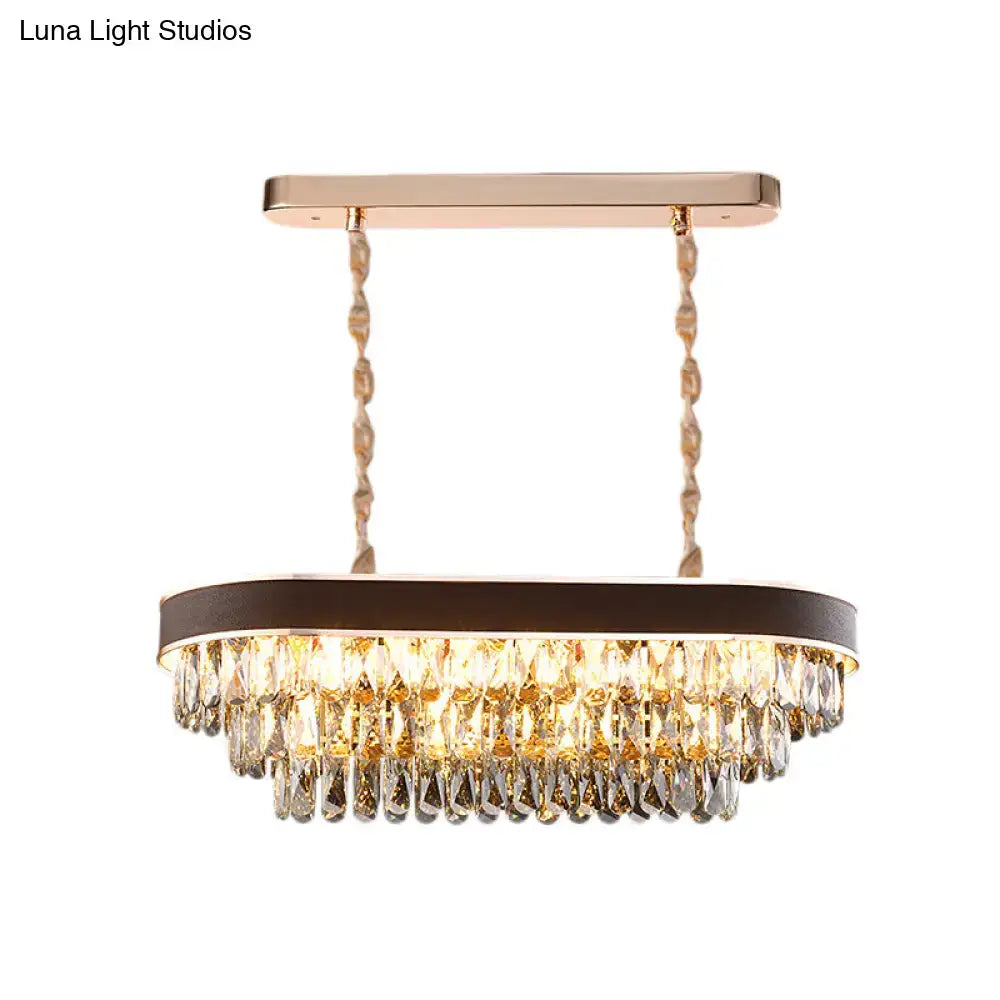 Gold-toned contemporary crystal block oval island lamp light fixture with cascading crystal droplets and modern design