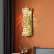Contemporary crystal wall sconce with embedded cubes in a gold-toned frame for bedroom decorbites wall sconce