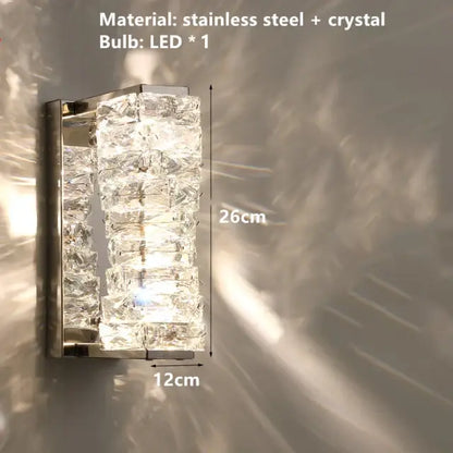 A contemporary crystal wall sconce with stacked faceted crystals in a sleek stainless steel decorbites contemporary crystal frame