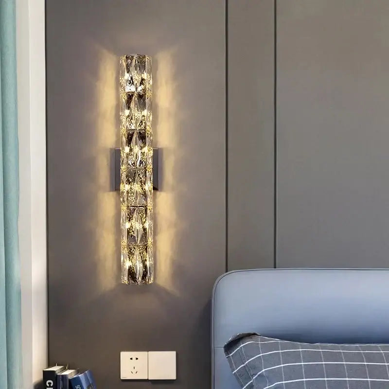 A contemporary crystal wall sconce with faceted crystal segments and a gold frame for elegant bedroom decorbites contemporary crystal lighting