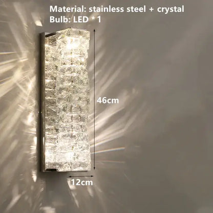 Contemporary crystal wall sconce with gold frame and stacked crystal facets in stainless steel decorbites contemporary crystal design
