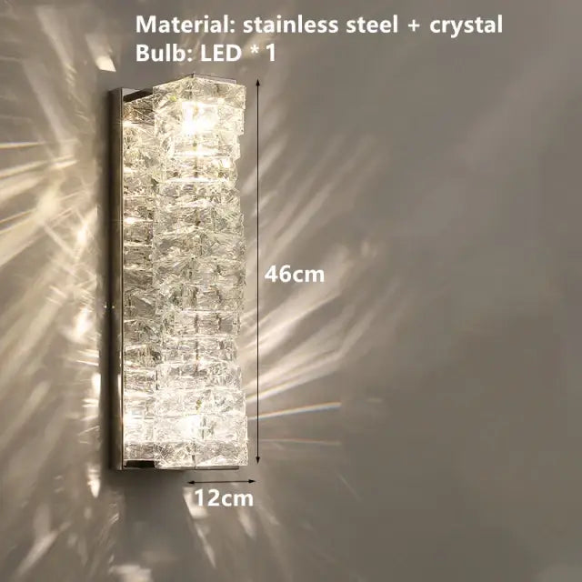 Contemporary crystal wall sconce with gold frame and stacked crystal facets in stainless steel decorbites contemporary crystal design