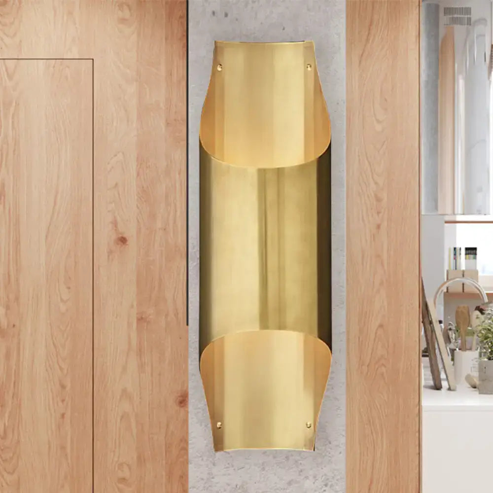 Contemporary curved brass wall lamp with polished finish and bulb base for elegant living room lighting design