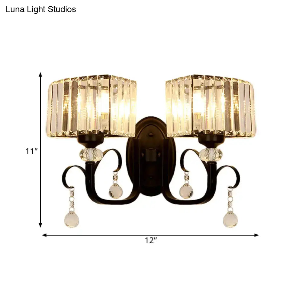 Elegant black wrought iron metal wall sconce with two crystal light fixtures and teardrop crystals, ideal as a wall lamp