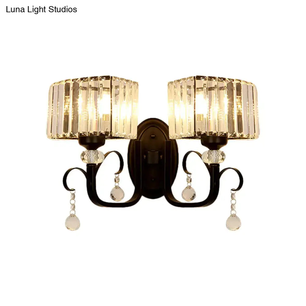 Elegant black wrought iron metal wall sconce with two crystal-encased teardrop fixtures for bedroom wall lamp lighting