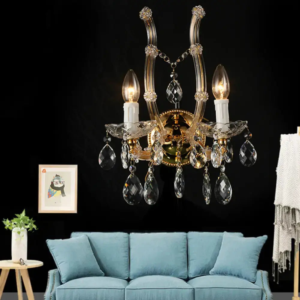 Contemporary gold amber glass crystal deco wall light fixture with three candle-style bulbs and faceted pendants