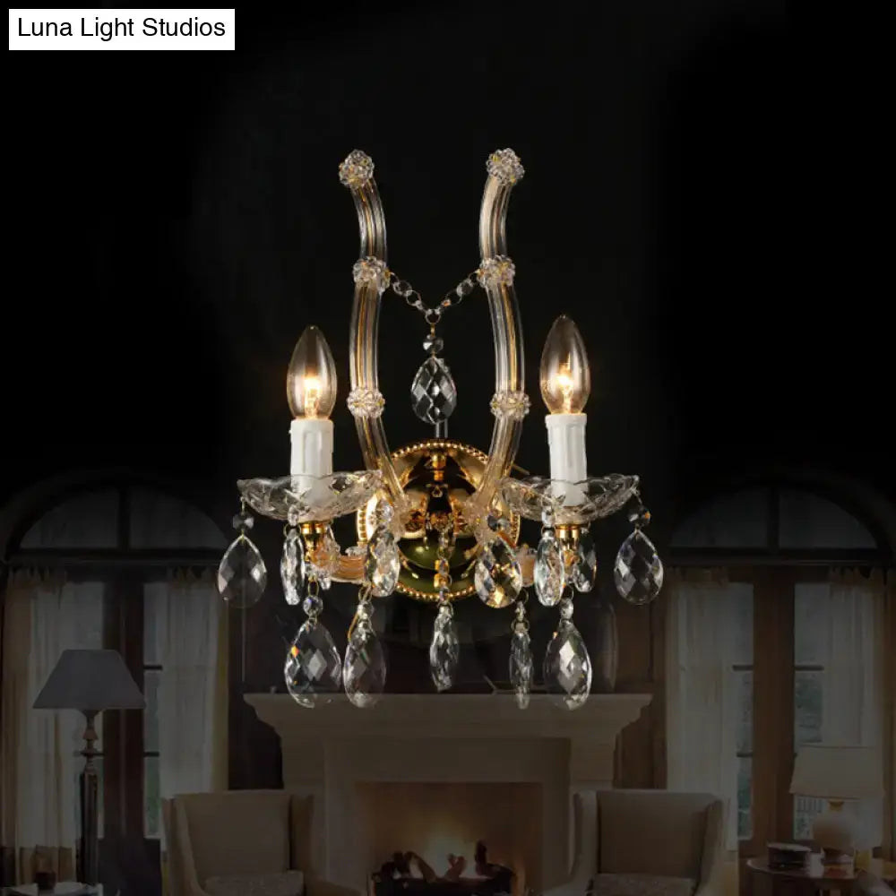 Elegant gold-toned crystal deco wall light featuring amber glass droplets and three candle-style bulbs with glass arms