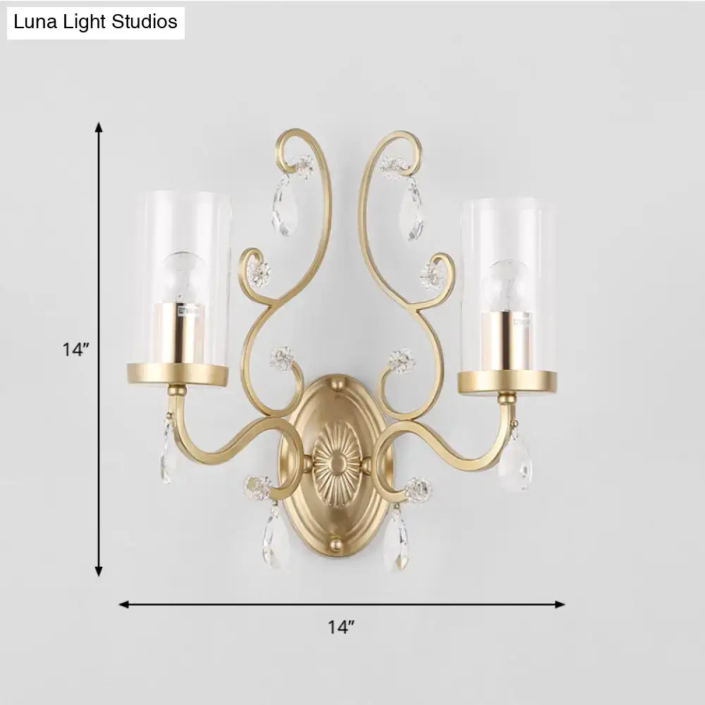 Contemporary gold wall light with clear glass candle-style shades and dangling crystal teardrops for bedroom decor