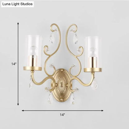 Contemporary gold wall light with clear glass candle-style shades and dangling crystal teardrops for bedroom decor