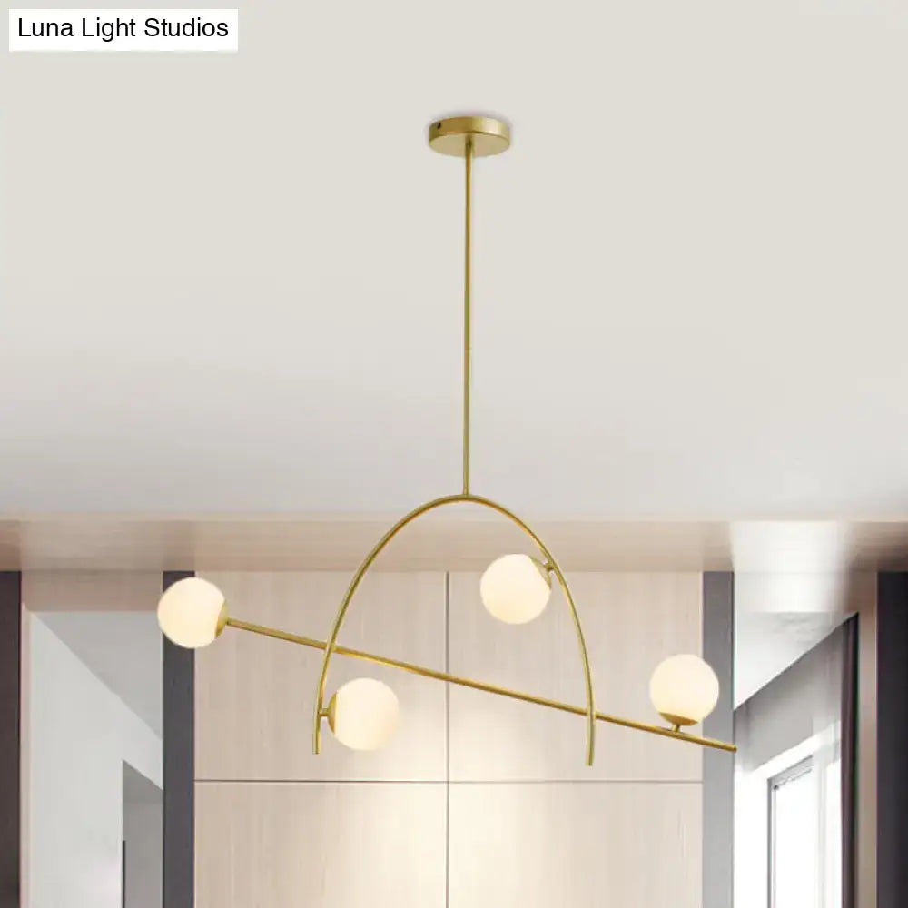 Decorbites™ contemporary chandelier lamp with four gold-toned metal arms and cream glass shade in warm white light