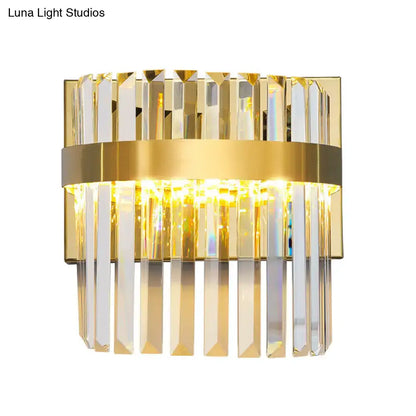 Contemporary gold crystal demilune cylinder wall light with vertical crystal prisms and central illuminated band for living room