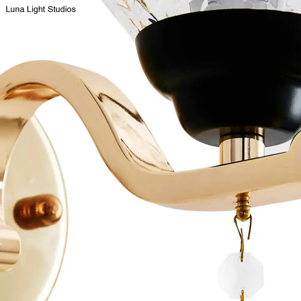 Contemporary gold wall sconce with black base and teardrop crystal drop accents for bedroom inch fixture lighting
