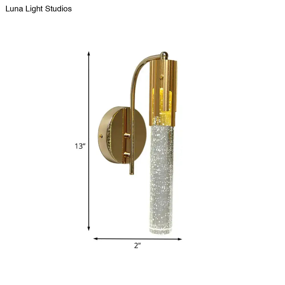 Contemporary gold-toned wall sconce with cylindrical crystal glass and embedded sparkling particles led light bulb included