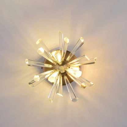 Contemporary gold crystal wall sconce with clear faceted rods and brass base, bulb base compatible, 18 inches tall