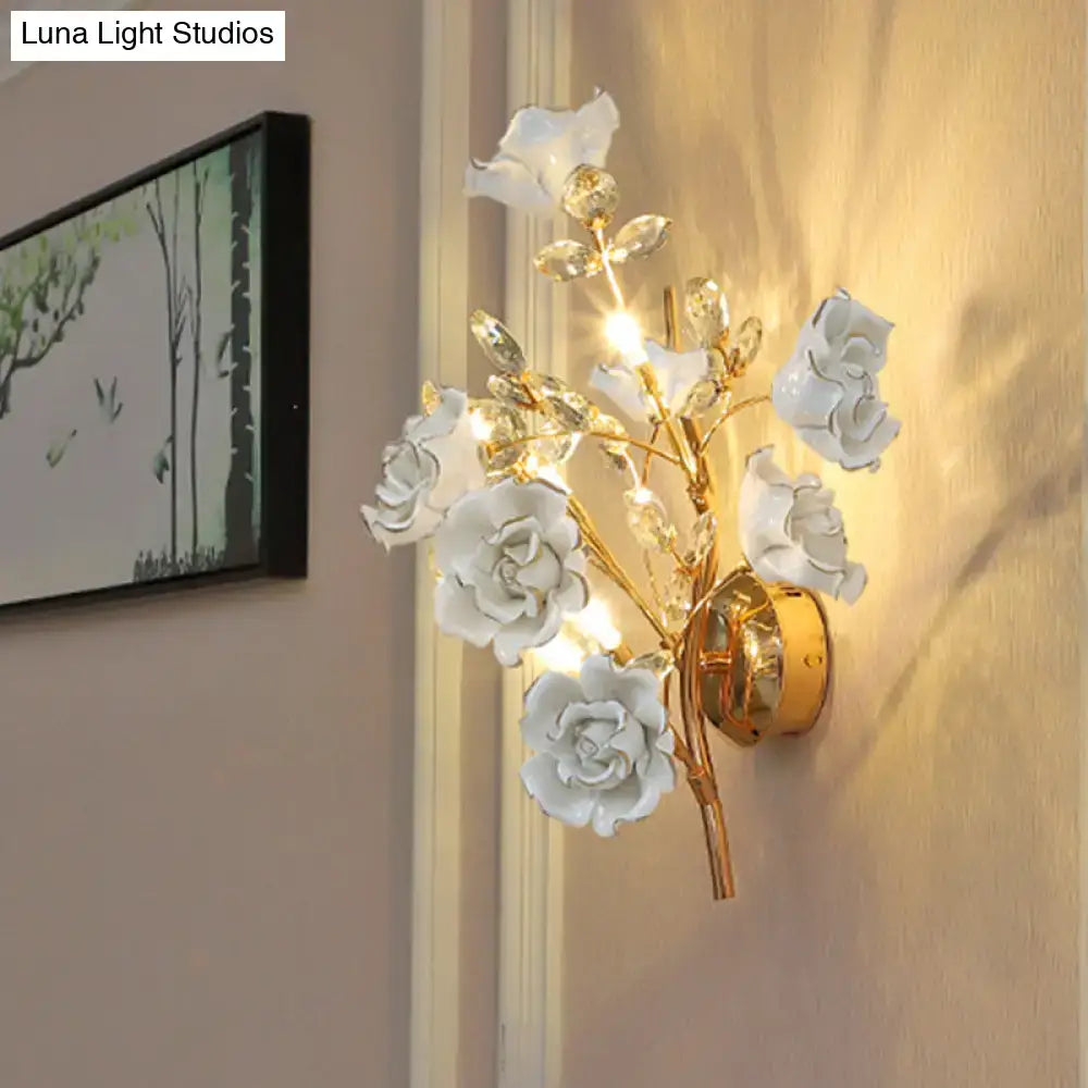 Elegant white ceramic rose wall lamp with gold-toned metal branches and crystal accents for contemporary wall light