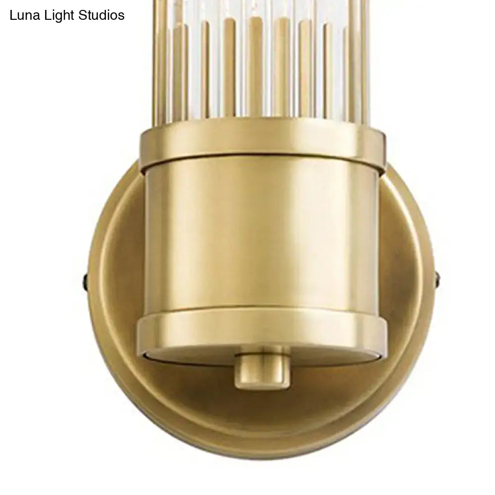 Contemporary gold crystal light fixture with brass finish and cylindrical glass shade with vertical clear rods for living room