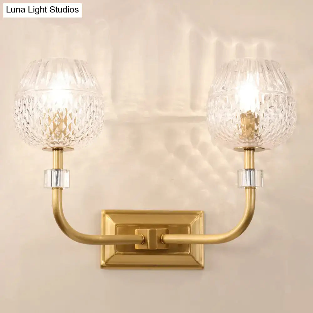 Gold-toned contemporary dome foyer wall light with two crystal globe shades featuring clear lattice glass pattern