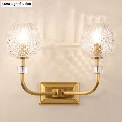 Gold-toned contemporary dome foyer wall light with two crystal globe shades featuring clear lattice glass pattern
