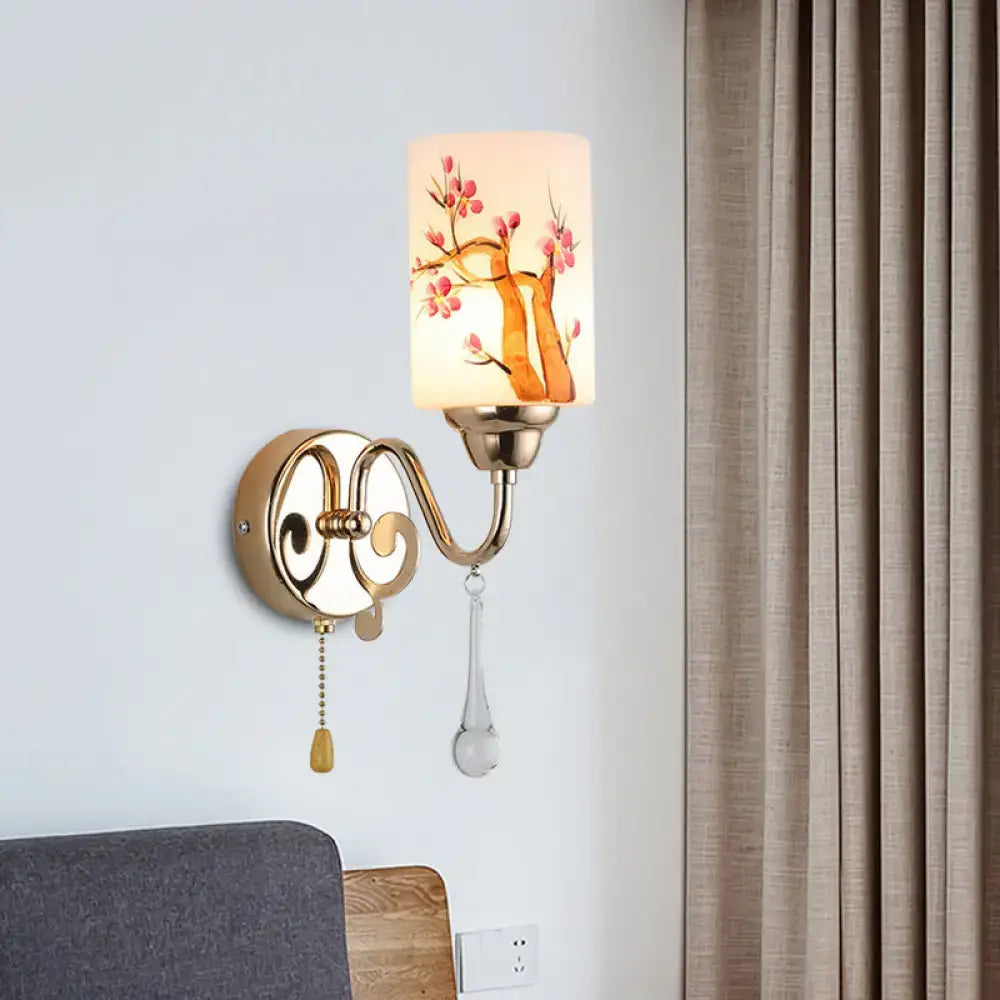 Contemporary wall lamp with gold finish metal frame and cream glass shade featuring pink cherry blossoms design