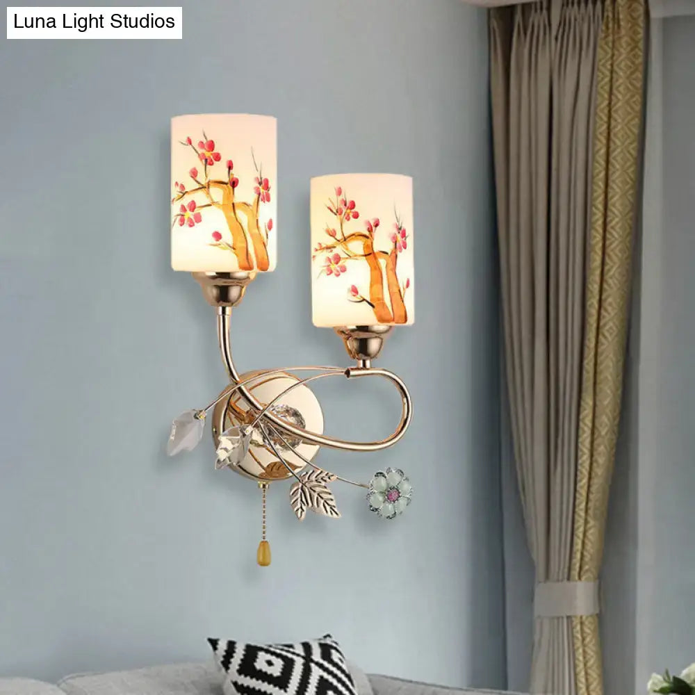 Contemporary gold finish wall lamp with cream glass shades featuring painted cherry blossom branches and crystal details