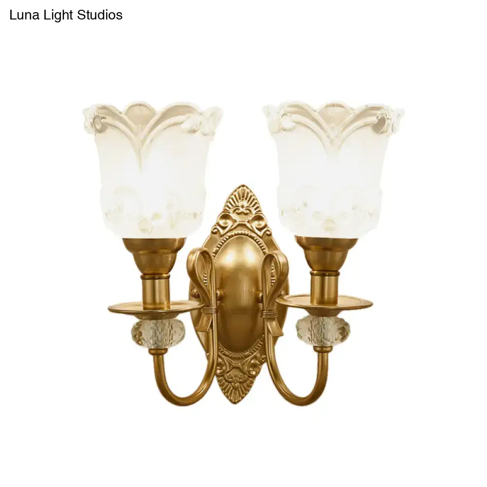 Antique gold-finished wall lamp with frosted glass petal shades and crystal accents for contemporary bedroom use
