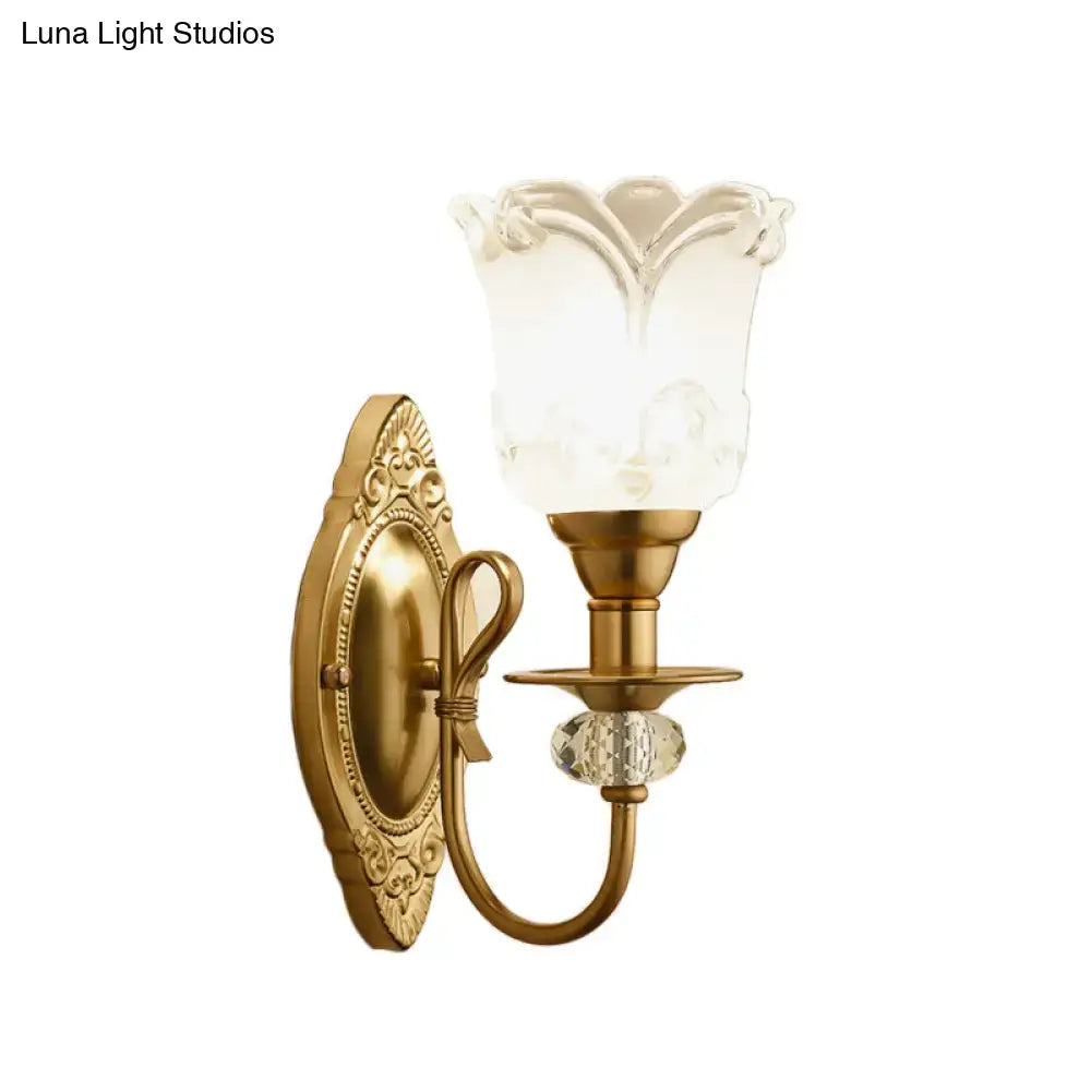 Antique brass wall lamp with frosted glass petal shade and faceted crystal accent for contemporary bedroom use