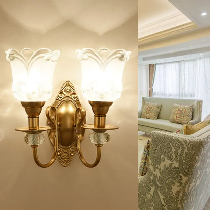 Contemporary gold wall lamp with frosted glass petal shades featuring floral detailing and crystal accents for bedroom