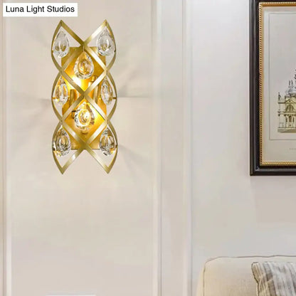 Contemporary gold geometric teardrop sconce with clear crystal accents for a living room light fixture
