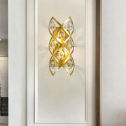 Contemporary gold geometric teardrop sconce light fixture with clear crystal accents for living room decor