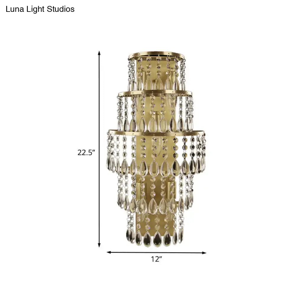 Contemporary gold layered bedside wall lamp featuring multiple tiers of dangling crystal teardrops and beads