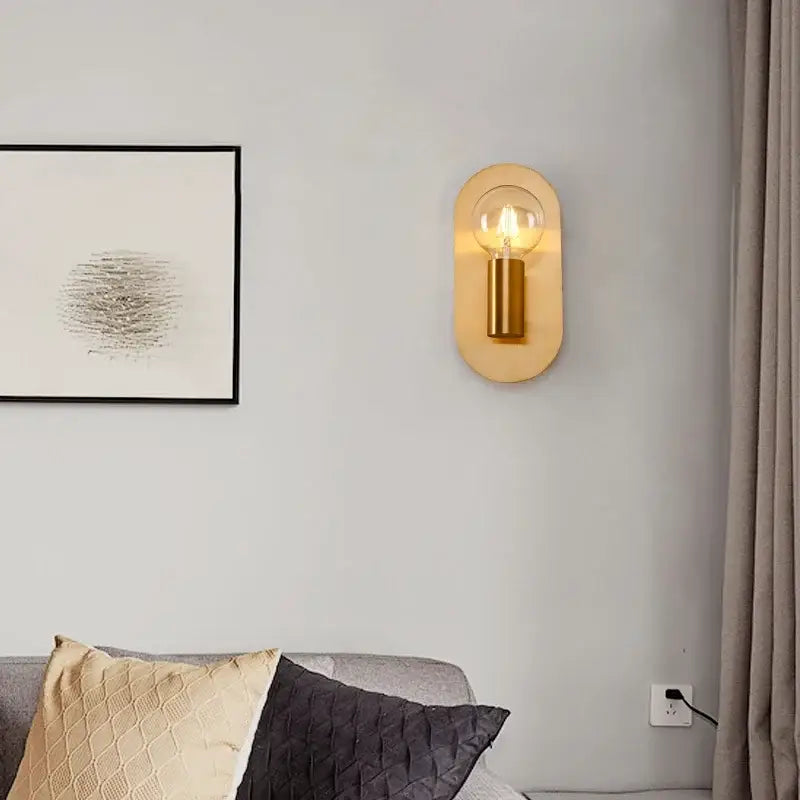 Contemporary gold led wall lamp with warm brass finish and oval wooden backplate featuring clear glass bulb for living room decorbites contemporary gold wall lamp