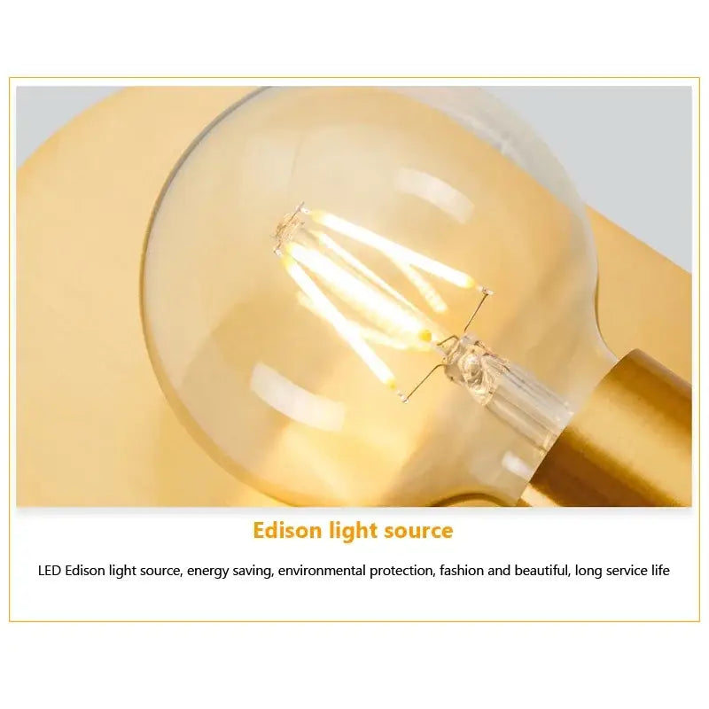 Warm-toned led edison bulb with clear glass and visible filament in a decorbites contemporary gold led wall lamp for living room