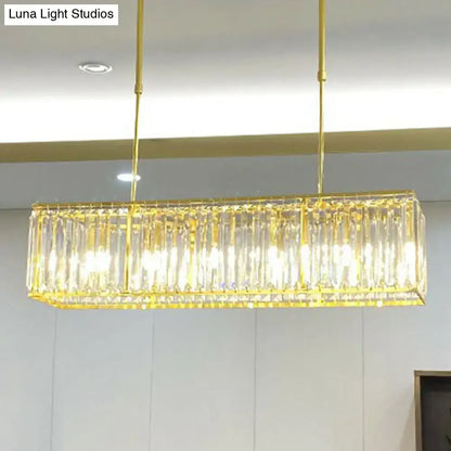 DecorBites contemporary gold rectangular island pendant light with vertical tri-prism crystal accents for dining room