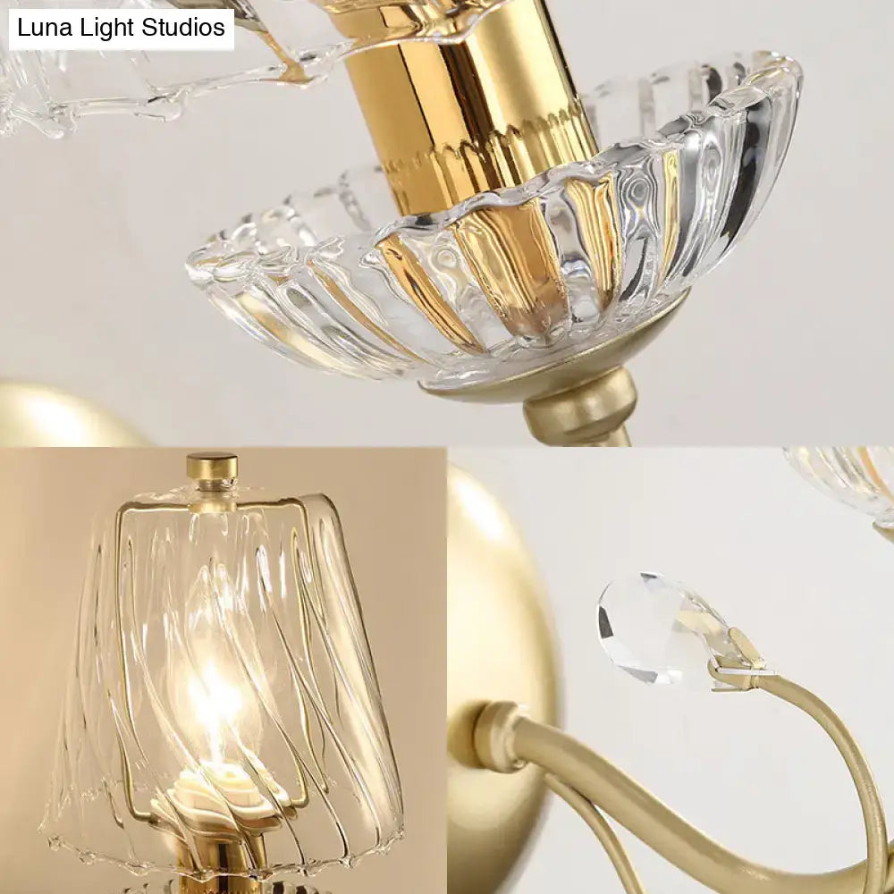 Contemporary gold-finished wall light with swirl glass shades crystal accents and e12 bulb base for bedroom use