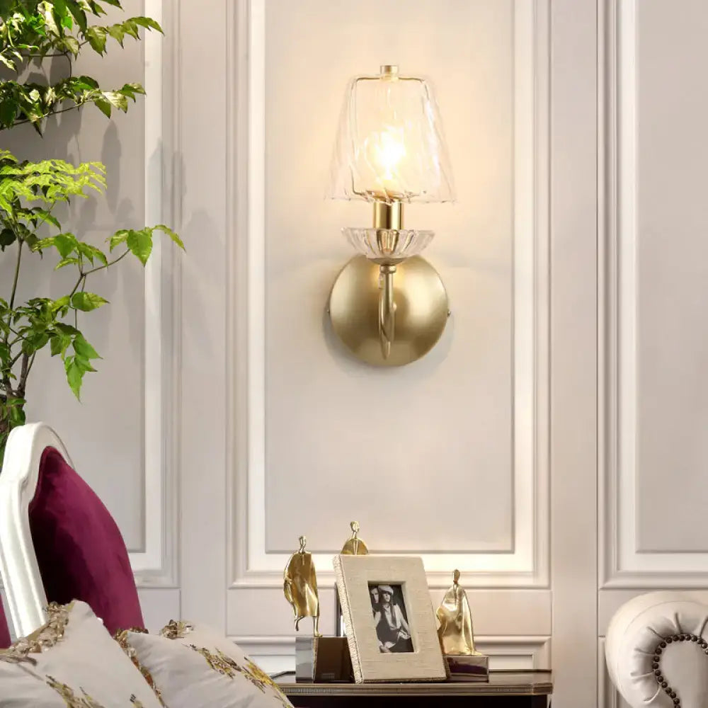 Contemporary gold swirl glass wall light with a decorative crystal base and e12 bulb base for bedroom use