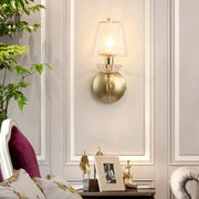 Contemporary gold swirl glass wall light with a decorative crystal base and e12 bulb base for bedroom use