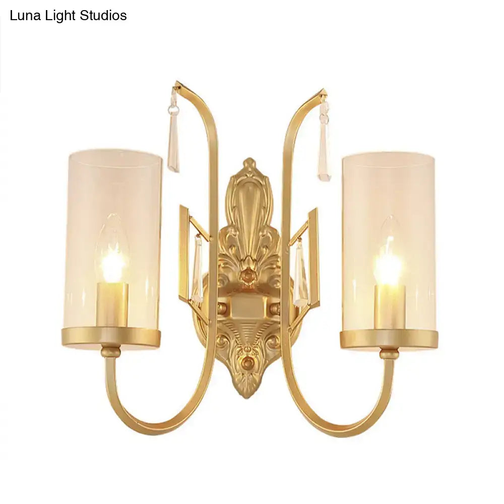 Contemporary gold wall light with clear glass shade, two cylindrical frosted glass shades, and crystal accents