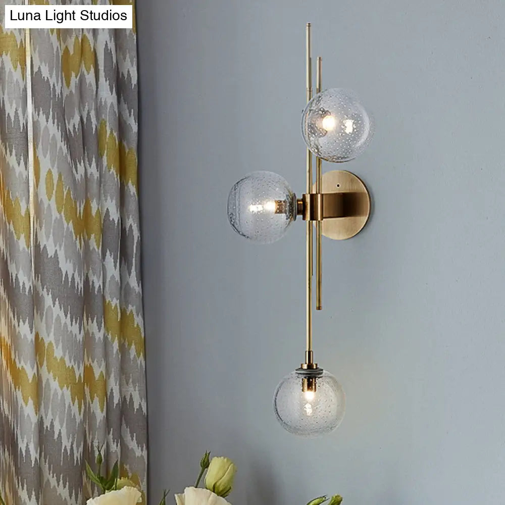 Aplique de pared DecorBites™ contemporáneo con globo de cristal verde/transparente y 3 luces en latón